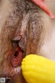 A close up of a woman's pussy with a yellow toy in her mouth.