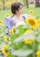 A woman standing in a field of sunflowers.